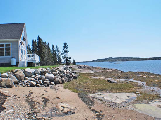 The cottage is on an island that is accessible in a car by a bridge